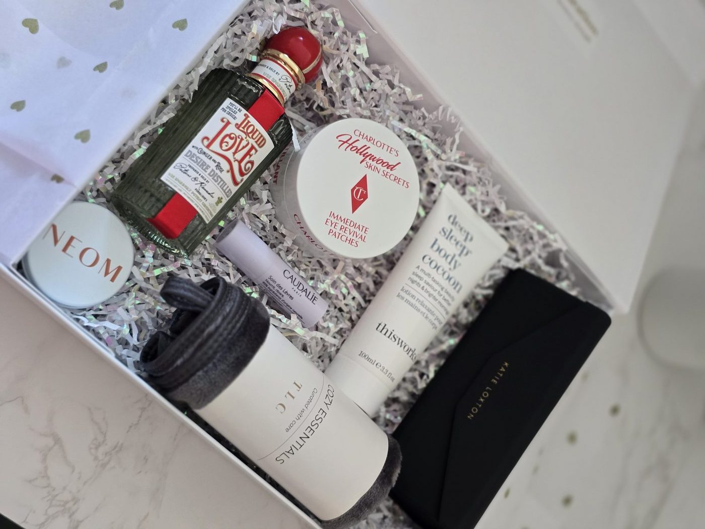 TLC box with Charlotte Tilbury and black clutch